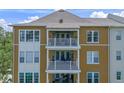 Exterior of multi-story home with private balconies and ample windows for natural light at 1200 Ironsmith Dr # 508, Celebration, FL 34747
