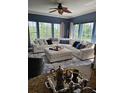 Spacious living room features large windows, comfortable seating, and stylish ceiling fan at 1200 Ironsmith Dr # 508, Celebration, FL 34747
