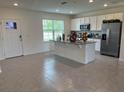 Bright kitchen features an island with a sink, stainless steel appliances, and plenty of cabinet space at 12035 Holystone St, Winter Garden, FL 34787