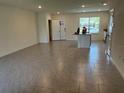 Open-concept living room featuring tile floors and ample natural light at 12035 Holystone St, Winter Garden, FL 34787
