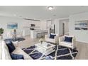 Bright and airy living room featuring an open floor plan and a dining area at 1345 Griffon Ave, Lake Alfred, FL 33850