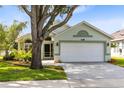 Inviting single-story home featuring mature landscaping and a spacious two-car garage at 139 Andrews Rd, Sanford, FL 32773