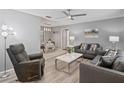Comfortable living room featuring a neutral color palette, wood floors, and an adjacent dining area at 1514 Sparrow St, Longwood, FL 32750