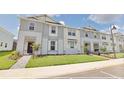 Attractive townhome community featuring well-manicured lawns and modern architectural design at 16129 Palm Frond Ave, Clermont, FL 34714