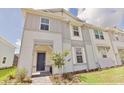 Stylish townhome showcasing a two-story facade, manicured lawn, and welcoming front entrance at 16129 Palm Frond Ave, Clermont, FL 34714