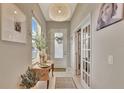 Bright foyer featuring a decorative light fixture, stylish console table, and tiled flooring at 1650 Key Bay Trl, Kissimmee, FL 34747
