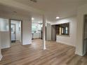 Bright living area with modern floors and paint, offering an open view of the newly remodeled kitchen at 2035 Voltaire St, Lakeland, FL 33801