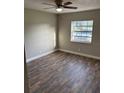 An inviting bedroom featuring stylish flooring, a ceiling fan, and natural light from the window at 2085 San Jose Blvd, Orlando, FL 32808