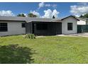 Charming single-story home with a screened porch, freshly painted exterior, and well-maintained lawn at 2085 San Jose Blvd, Orlando, FL 32808