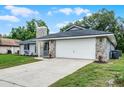 Charming single Gathering home with stone accents and a well-maintained lawn and two car garage at 229 Marcum Trace Dr, Lakeland, FL 33809