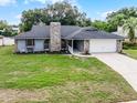 Charming single Gathering home with stone accents and a well-maintained lawn and two car garage at 229 Marcum Trace Dr, Lakeland, FL 33809