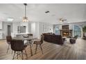 Open-concept living room with a stone fireplace, dining area, and kitchen access at 229 Marcum Trace Dr, Lakeland, FL 33809
