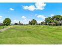 Scenic view of the community golf course with lush green grass and mature trees on a sunny day at 2520 Nw 53Rd Avenue Rd, Ocala, FL 34482
