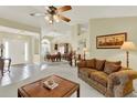 Inviting living room featuring a classic sofa, chandelier, and elegant furnishings for a comfortable ambiance at 2520 Nw 53Rd Avenue Rd, Ocala, FL 34482