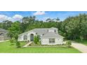 Beautiful home with lush green lawn and mature trees enhancing its curb appeal at 2908 Lee Shore Loop, Orlando, FL 32820