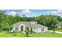 A beautiful house with a neatly manicured lawn, shrubs, and lush trees at 2908 Lee Shore Loop, Orlando, FL 32820
