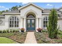 Inviting home entrance featuring a stylish front door and colorful flowers at 2908 Lee Shore Loop, Orlando, FL 32820