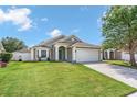 Charming single-Gathering home featuring a well-manicured lawn and a two-car garage at 2913 Wilshire Rd, Clermont, FL 34714