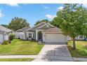 Charming single-Gathering home featuring a well-manicured lawn and a two-car garage at 2913 Wilshire Rd, Clermont, FL 34714