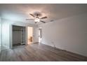 Bright bedroom features wood-look floors, a ceiling fan, and an organized closet space at 3149 Quail Dr, Deltona, FL 32738