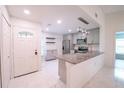 Updated kitchen featuring granite countertops and stainless steel appliances, and gray cabinets near the front door at 3149 Quail Dr, Deltona, FL 32738