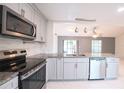 An updated kitchen featuring stainless steel appliances and a view to the living room at 3149 Quail Dr, Deltona, FL 32738