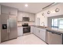 Updated kitchen featuring stainless steel appliances and granite countertops, and gray cabinets at 3149 Quail Dr, Deltona, FL 32738