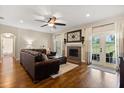 Comfortable living room with hardwood floors, fireplace and French doors leading to a large backyard at 3201 Oaklea Dr, Deland, FL 32720