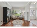 Bright living room with hardwood floors, plush chairs, large windows with shutters, and elegant decor at 405 Courtlea Park Dr, Winter Garden, FL 34787