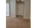 Entryway featuring neutral carpet and tile, leading to the main living area with natural light at 4371 Aqua Vista Dr # G, Orlando, FL 32839