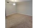 Inviting living area featuring neutral walls, carpet, and a classic light fixture at 4371 Aqua Vista Dr # G, Orlando, FL 32839