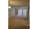 Bright living room with carpet, a ceiling fan, and large windows offering ample natural light at 4371 Aqua Vista Dr # G, Orlando, FL 32839