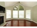 Spacious living room boasts wood floors, a fireplace, and abundant natural light from large windows at 620 Glenwood Ct # 79, Altamonte Springs, FL 32714