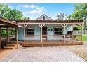 Inviting front porch with a swing, decorative railings, and brick paved driveway at 740 Florida Blvd, Altamonte Springs, FL 32701