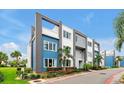 Modern building exterior with blue accents, manicured landscaping and an inviting street view at 7740 Sandy Ridge Dr # 114, Reunion, FL 34747