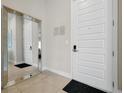 Welcoming condo entrance featuring a mirrored wall and a modern white door at 7740 Sandy Ridge Dr # 114, Reunion, FL 34747