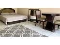 Well-lit bedroom featuring a comfortable bed and tile flooring at 7900 S Orange Blossom Trl # 2108, Orlando, FL 32809