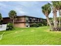 Motel exterior with lush green lawn and tropical landscaping at 7900 S Orange Blossom Trl # 2108, Orlando, FL 32809