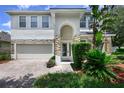 Charming two-story home with stone accents, manicured landscaping and a brick driveway at 809 Kazaros Cir, Ocoee, FL 34761