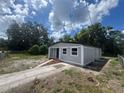 Well-maintained single-story home with a sidewalk, fresh exterior paint, and lovely landscaping at 8320 Dominguin St, Orlando, FL 32817