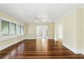 Spacious living room featuring gleaming hardwood floors, a ceiling fan, and bright natural light at 835 Antonette Ave, Winter Park, FL 32789