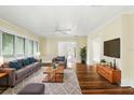 Bright living room with hardwood floors, a ceiling fan, and neutral decor creating a cozy atmosphere at 835 Antonette Ave, Winter Park, FL 32789
