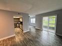 Open concept living area with sliding glass doors, leading to the kitchen at 9918 Turf Way # 5, Orlando, FL 32837