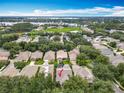 Expansive aerial view of a residential neighborhood, highlighting the property's location near a lake at 12641 Arley Dr, Windermere, FL 34786