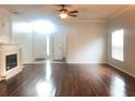 Open living room with hardwood floors, fireplace, and ample natural light, creating a warm atmosphere at 10513 Leader Ln, Orlando, FL 32825