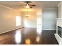 Bright living room featuring hardwood floors, a ceiling fan and a decorative fireplace at 10513 Leader Ln, Orlando, FL 32825