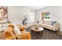 Inviting living room with wood flooring, comfortable seating, and a view into a bedroom at 108 Devon Ct, Longwood, FL 32779