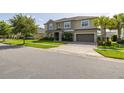Charming two-story home featuring manicured lawn, a paved driveway, and a two-car garage at 1113 Fieldstone Cir, Oviedo, FL 32765
