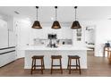 Modern kitchen with white cabinets, a large island with seating, and stainless steel appliances at 1203 Pearl Tree Rd, Deltona, FL 32725