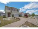 Two-story home boasts a two-car garage, landscaped front yard, and welcoming entrance at 129 Eagleview Loop, Davenport, FL 33837
